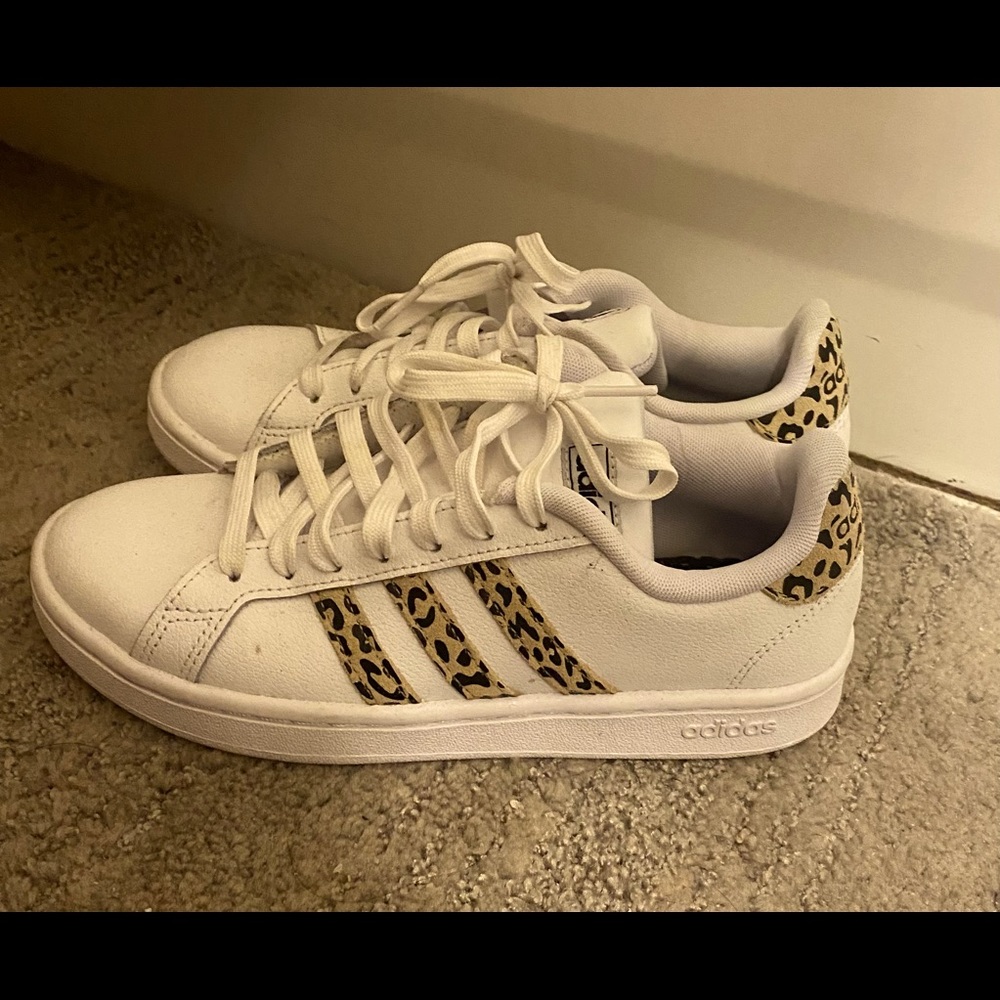 Adidas leopard print and white athletic shoes.